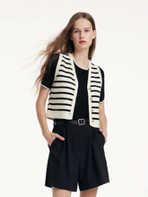 a lady in strip knitted vest with black shorts